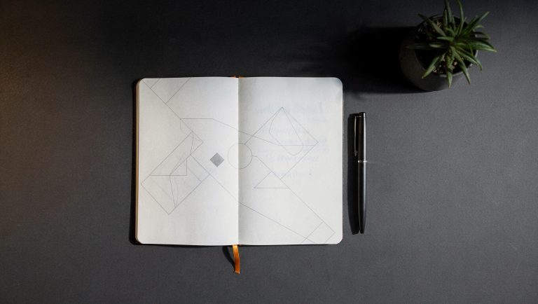 Clean minimal desk workspace with open notebook and strategic roadmap lines, representing B2B marketing strategy leadership